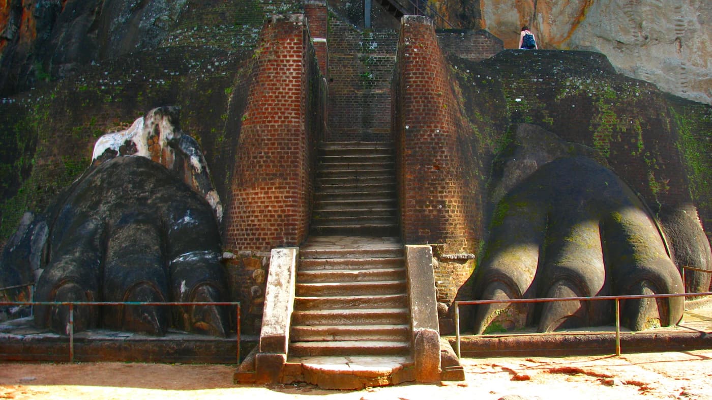 The final staircase of Sigiriya rising between two enormous stone lion paws