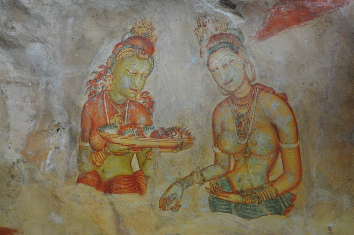 Two of the fifth-century painted maidens of Sigiriya holding flowers