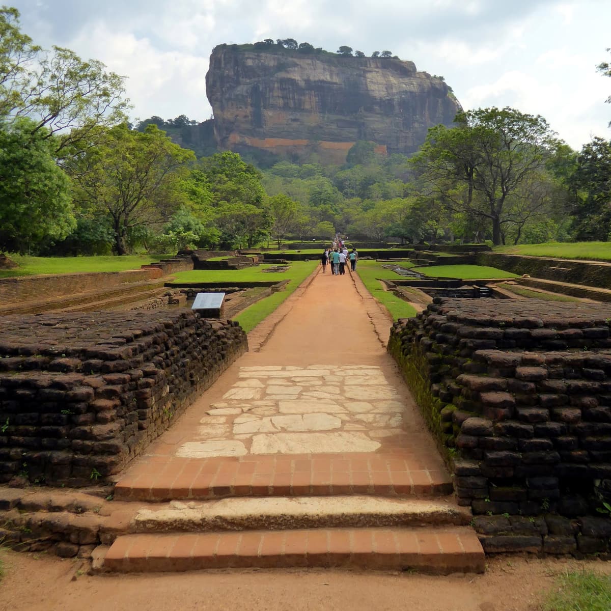 A brick-lined path through the water gardens leading towards Sigiriya rock